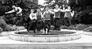 Groom and his best men jumping for joy at his wedding at Pinewood Hotel, Slough