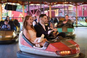 Wedding guests having fun at Carter's Steam Fair on the dodgems